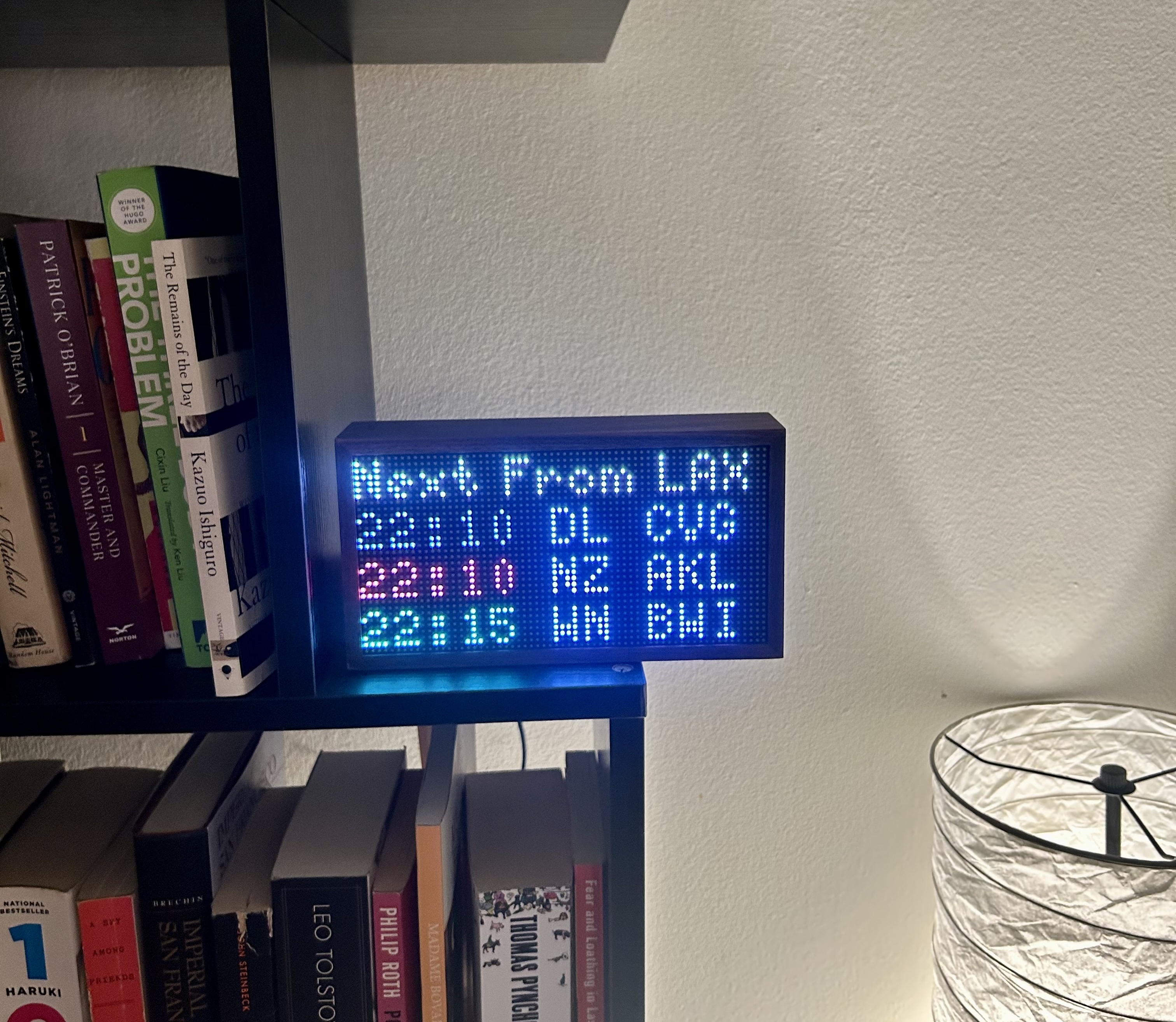 Tidbyt screen showing LAX departures