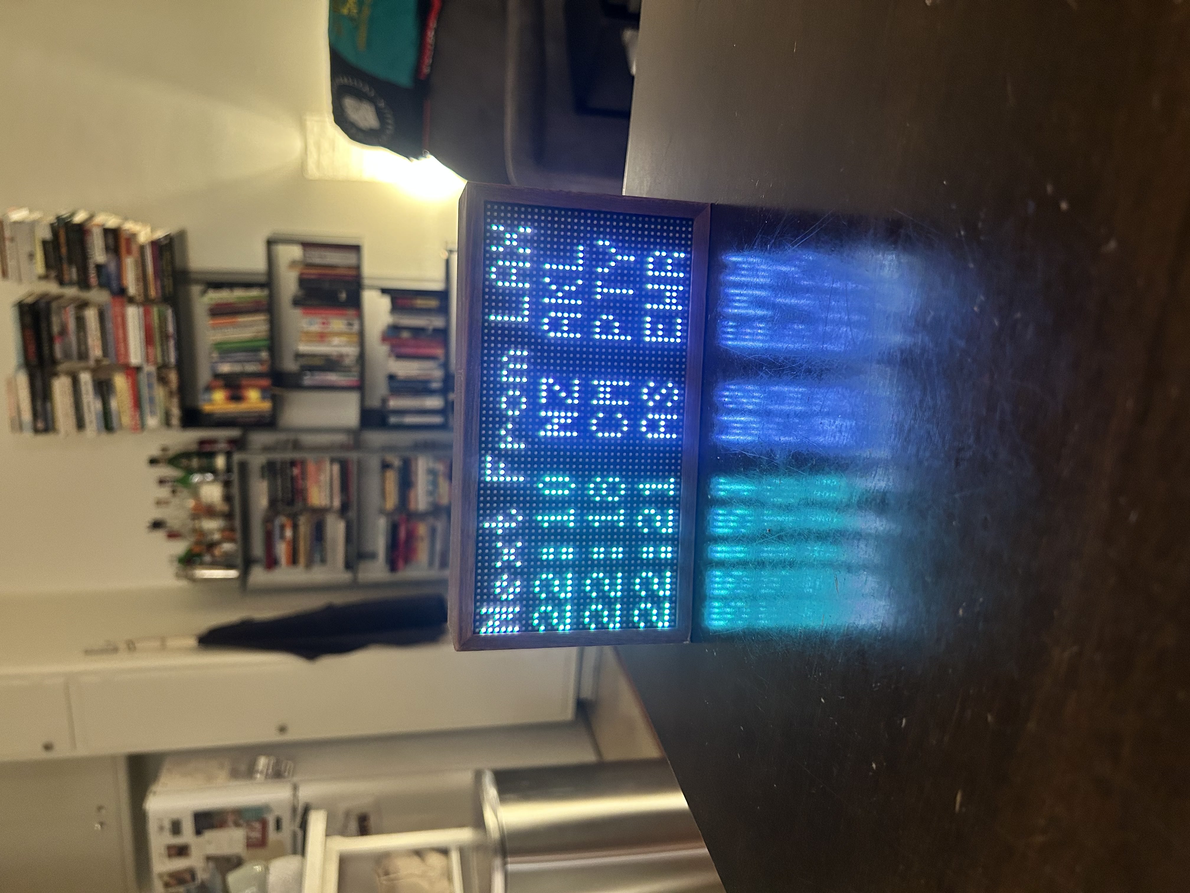 Tidbyt on table with departure screen 3